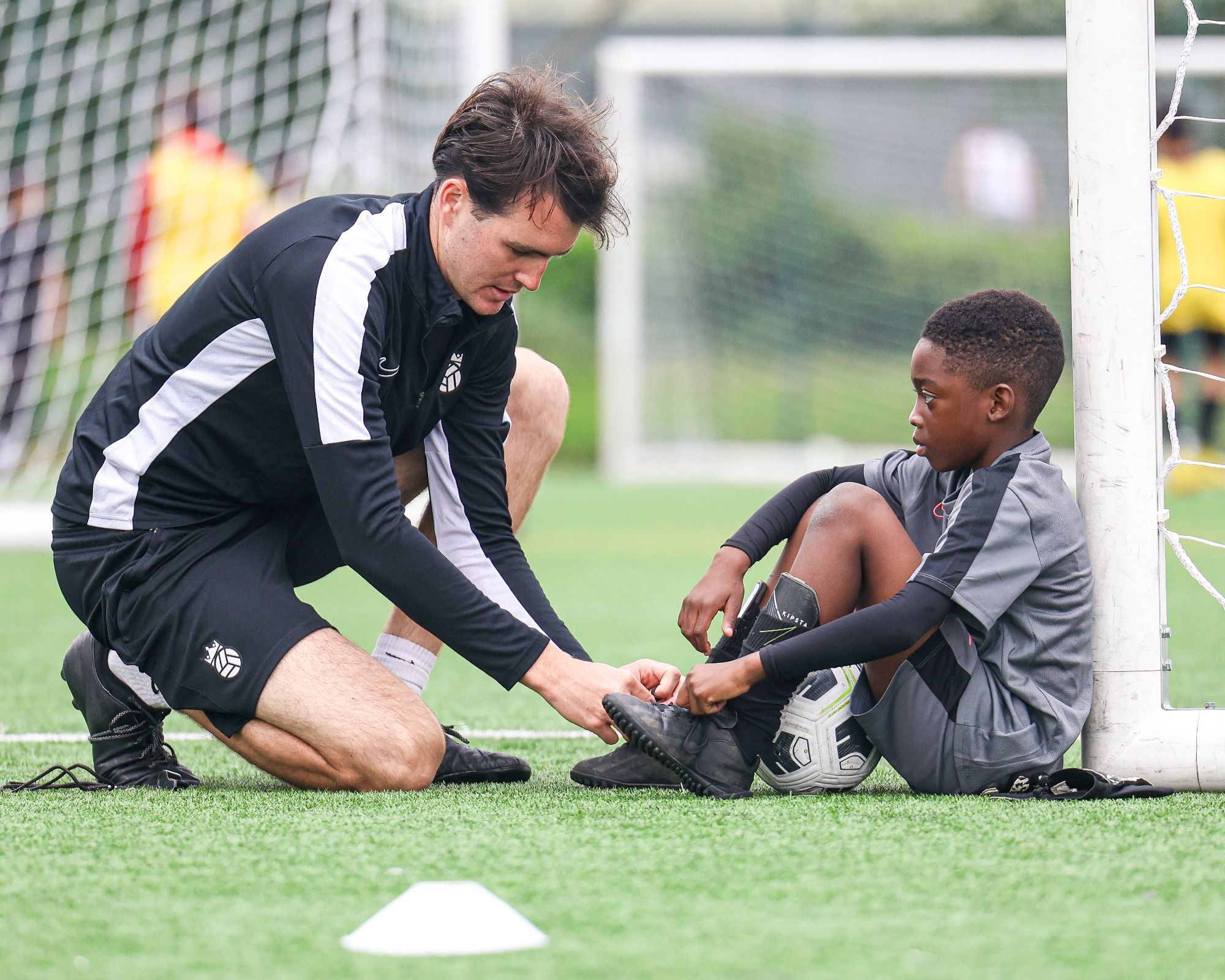 Bloomsbury Football Foundation coach ties his player's laces