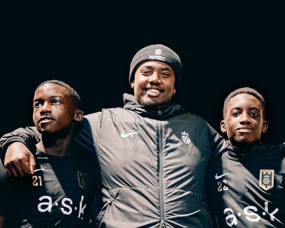 Bloomsbury Football Foundation players pose on pitch with coach
