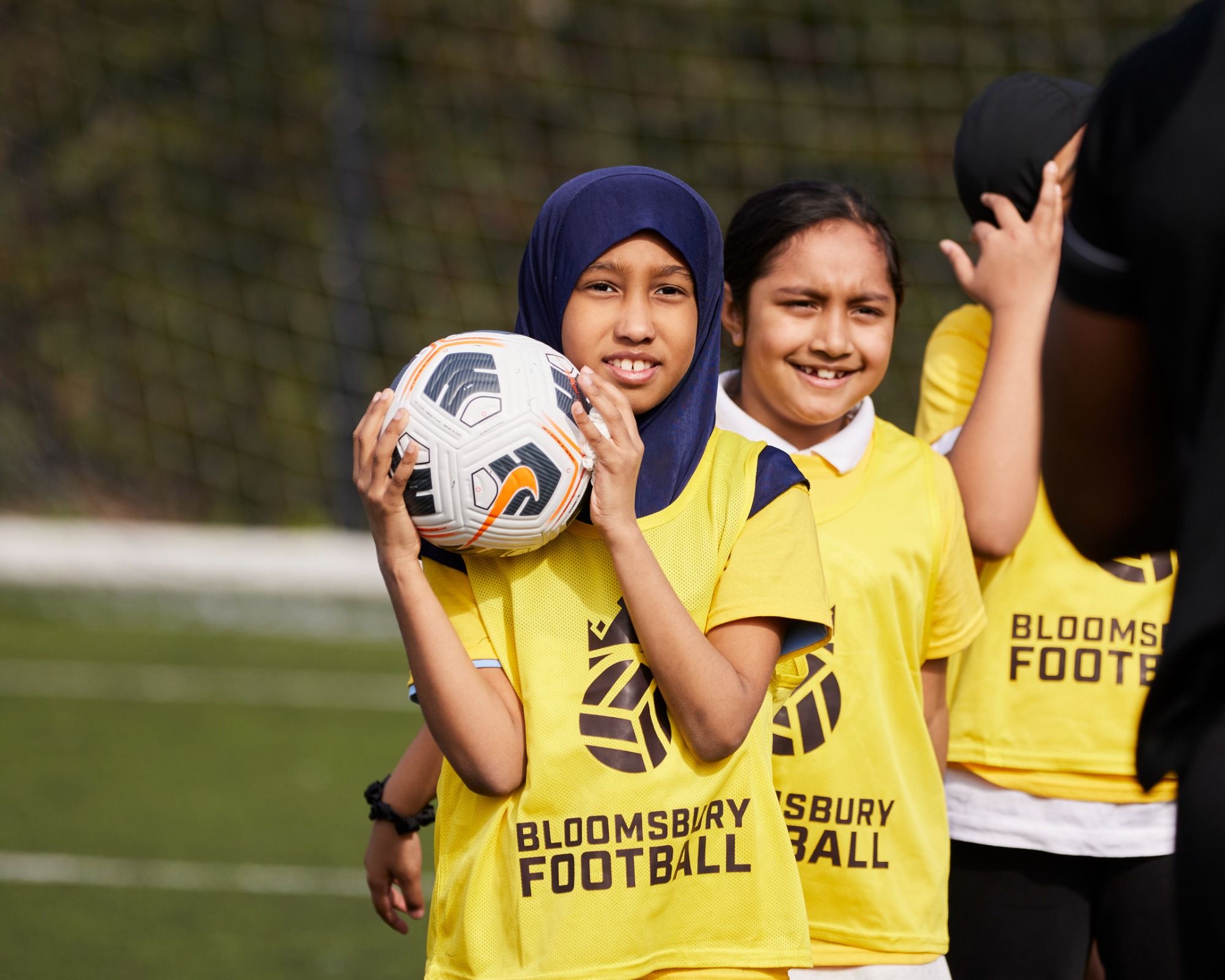 Bloomsbury Football Foundation players smile together on pitch