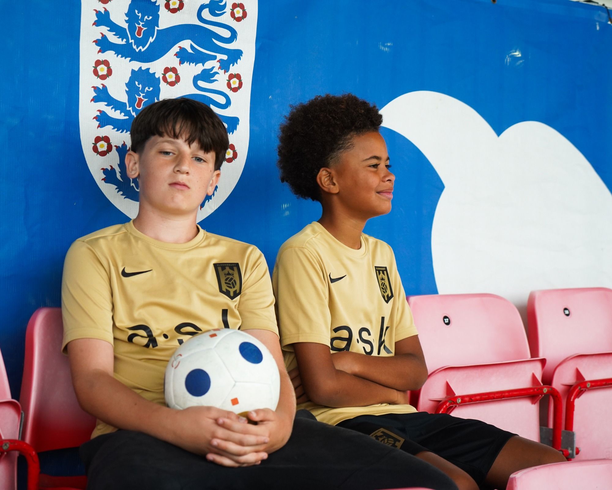Bloomsbury Football Foundation players pose in the stands of a football stadium