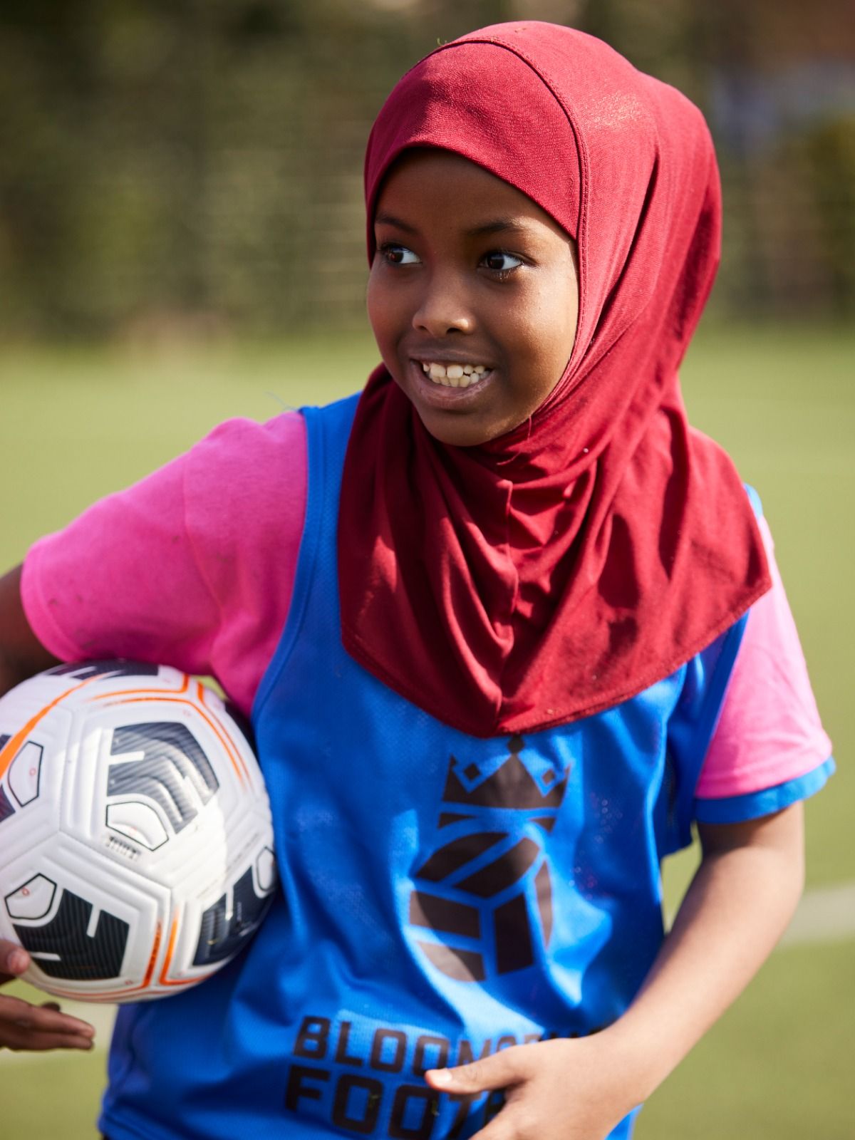 Bloomsbury Football Foundation player smiling holding football