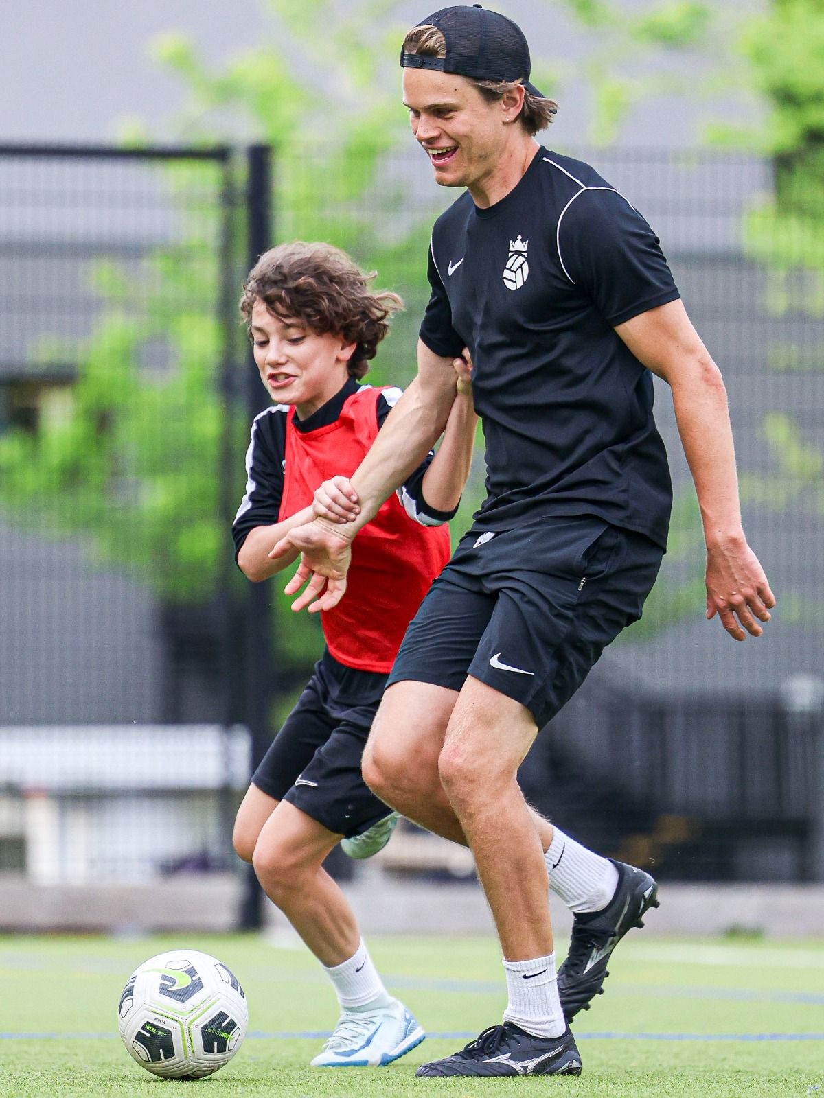 Bloomsbury Football Foundation coach and player running together